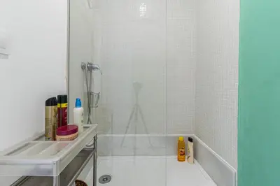 a white bathroom with a shower and a sink at Allo Apartments Plaza Arenal Centro 2 Habitaciones in Jerez de la Frontera