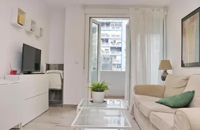 a living room with a couch and a tv at Apartamento Madrid in Cádiz