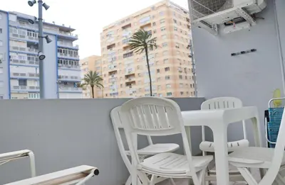 two white chairs and a table on a balcony at Apartamento Madrid in Cádiz