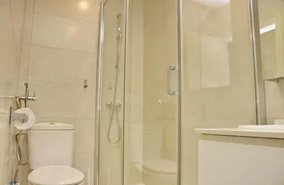 a bathroom with a shower with a toilet and a sink at Apartamento Madrid in Cádiz