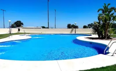 a large swimming pool with blue water at Apartamento Angel in San Fernando