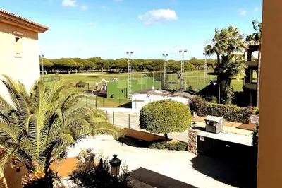a view of a park with a tennis court at Novo Sancti Petri, La Barrosa, 2 Beds Room Apartamento by Chiclana Dreams in Chiclana de la Frontera