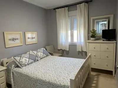 a small bedroom with a bed and a window at Apartamento excelente ubicación en Novo Sancti Petri By Chiclana Dreams in Chiclana de la Frontera