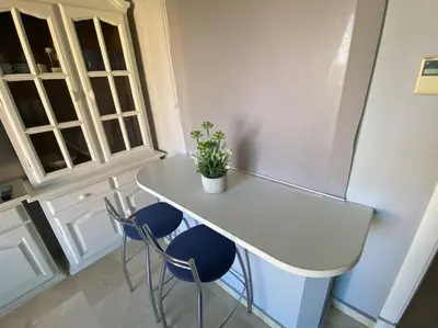 a white table with two chairs and a potted plant on it at Apartamento excelente ubicación en Novo Sancti Petri By Chiclana Dreams in Chiclana de la Frontera