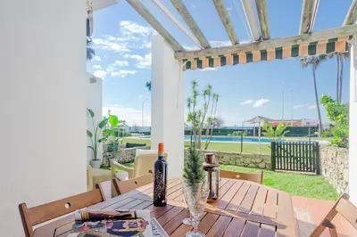 a dining room with a table with a view of the ocean at Laja Bermeja, piscina y primera línea de La Barrosa in Chiclana de la Frontera