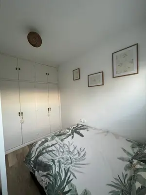 a bedroom with a bed and white cabinets at Precioso Apto con vistas al Parque Nacional Doñana in Chipiona