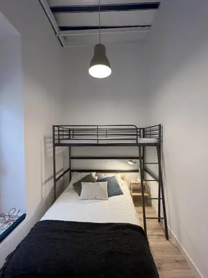 a bedroom with a bunk bed in a room at Patiovecino Apartment Centro de Cádiz in Cádiz
