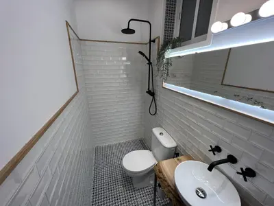a bathroom with a white toilet and a sink at Patiovecino Apartment Centro de Cádiz in Cádiz