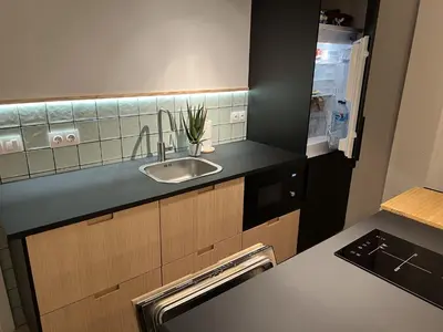 a kitchen with a sink and a refrigerator at Patiovecino Apartment Centro de Cádiz in Cádiz