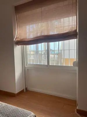 a room with a window with a curtain and a bed at Apartamento Veracruz in Rota