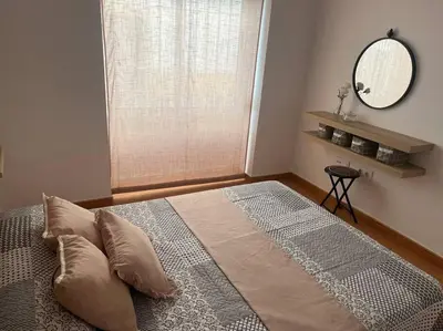 a bedroom with a large bed with a large window at Apartamento Veracruz in Rota