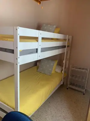 a bedroom with two bunk beds with yellow sheets at Piso coqueto céntrico en Jerez (San Miguel) in Jerez de la Frontera