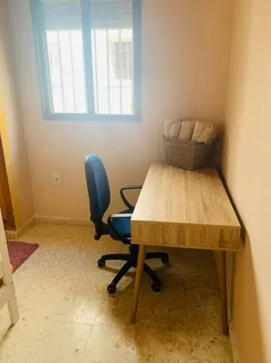 a room with a table and a chair and a window at Piso coqueto céntrico en Jerez (San Miguel) in Jerez de la Frontera
