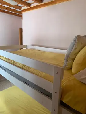 a bedroom with a bunk bed with yellow sheets at Piso coqueto céntrico en Jerez (San Miguel) in Jerez de la Frontera