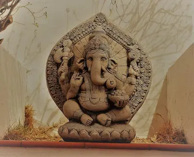 a stone statue of a deity sitting on the ground at CÁDIZ - GANESHA acogedor apartamento en Chiclana de la Frontera, España in Chiclana de la Frontera