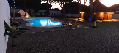 an overhead view of a swimming pool at night at CÁDIZ - GANESHA acogedor apartamento en Chiclana de la Frontera, España in Chiclana de la Frontera