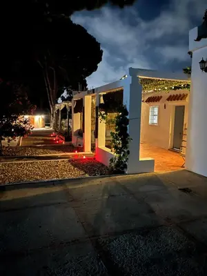 a house decorated with christmas lights at night at CÁDIZ - GANESHA acogedor apartamento en Chiclana de la Frontera, España in Chiclana de la Frontera