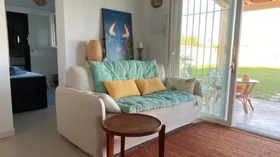 a living room with a couch and a table at Casa Costa Ecologica y de Design con Piscina, Jardin y Parking in Chiclana de la Frontera
