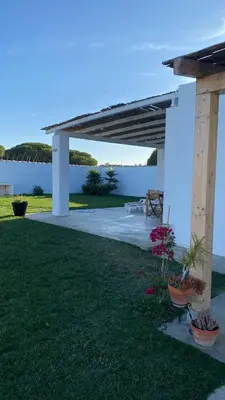 a pergola with a view of the water at Casa Costa Ecologica y de Design con Piscina, Jardin y Parking in Chiclana de la Frontera