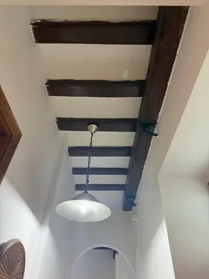 a room with a ceiling with a light on it at Apartamento Casa Palacio 1890. in El Puerto de Santa María