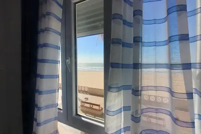 a window with a view of the beach at AranPe PLAYA CÁDIZ in Cádiz