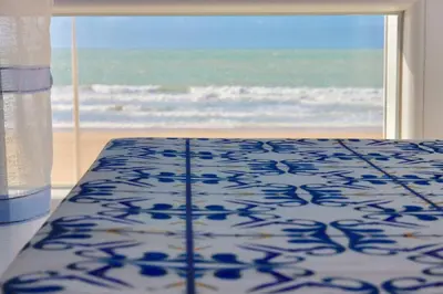 a bedroom with a bed with a view of the ocean at AranPe PLAYA CÁDIZ in Cádiz
