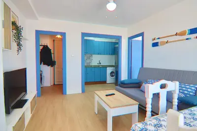 a living room with a couch and a table at AranPe PLAYA CÁDIZ in Cádiz