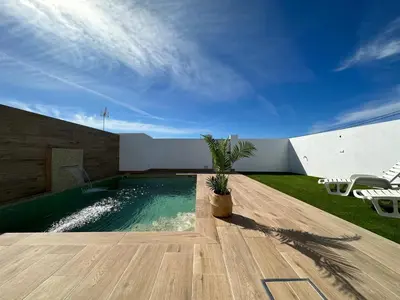 a swimming pool in the middle of a yard at Sumatra Chalet in Chiclana de la Frontera