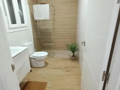 a bathroom with a toilet and a sink and a shower at Sumatra Chalet in Chiclana de la Frontera