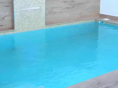 a swimming pool with blue water at Sumatra Chalet in Chiclana de la Frontera