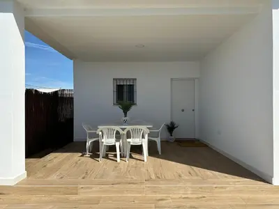 a dining room with a table and two chairs at Sumatra Chalet in Chiclana de la Frontera