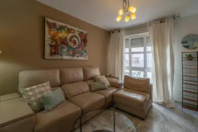 a living room with a couch and a table at Apartamento Cadiz Be Kind in Cádiz