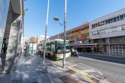 a bus parked on the side of a city street at Apartamento Cadiz Be Kind in Cádiz