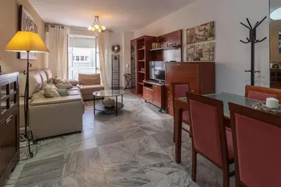 a living room with a table and a couch at Apartamento Cadiz Be Kind in Cádiz