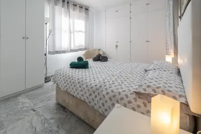 a bedroom with a bed with two stuffed animals on it at Apartamento Cadiz Be Kind in Cádiz