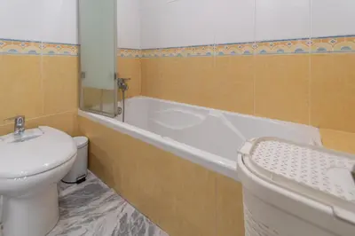 a bathroom with a tub and a toilet and a sink at Apartamento Cadiz Be Kind in Cádiz