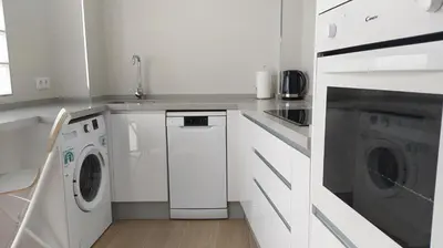 a white laundry room with a washer and dryer at Sherryflat Porvenir in Jerez de la Frontera