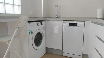 a white kitchen with a washing machine and a sink at Sherryflat Porvenir in Jerez de la Frontera
