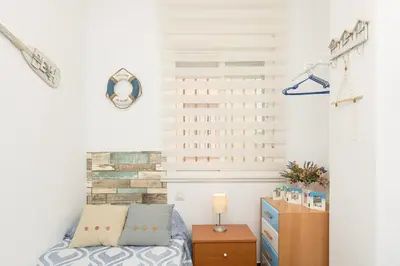 a bedroom with a bed and a wooden dresser at El Deseo in Chiclana de la Frontera