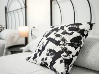 a black and white pillow sitting on a bed at Colon 1 in El Puerto de Santa María