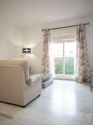 a living room with a couch and a window at Colon 1 in El Puerto de Santa María
