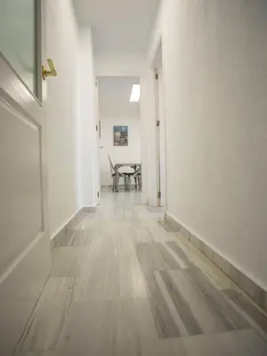 an empty hallway with a table in a room at Colon 1 in El Puerto de Santa María