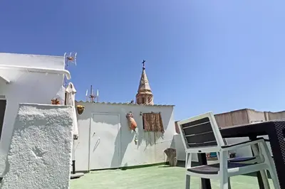 a chair sitting on the roof of a house at ÁTICO SANTA MARÍA in Cádiz