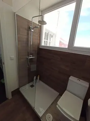 a bathroom with a glass shower and a toilet at ÁTICO SANTA MARÍA in Cádiz