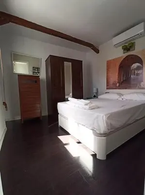 a bedroom with two white beds and a dresser at ÁTICO SANTA MARÍA in Cádiz