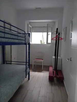 a room with two bunk beds and a window at APARTAMENTO VEEDOR 19 DÍAS Y MUCHAS NOCHES in Cádiz