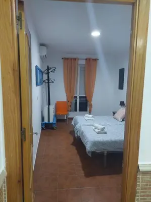 a small bedroom with a bed and a room with at APARTAMENTO SANTA MARÍA in Cádiz