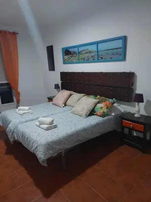a bedroom with a bed with two towels on it at APARTAMENTO SANTA MARÍA in Cádiz