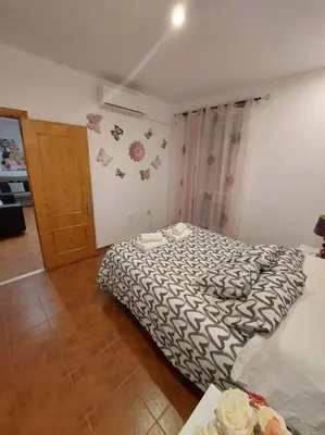 a bedroom with a black and white bed and a door at APARTAMENTO SANTA MARÍA in Cádiz