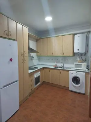 a kitchen with a white refrigerator and a dishwasher at APARTAMENTO SANTA MARÍA in Cádiz